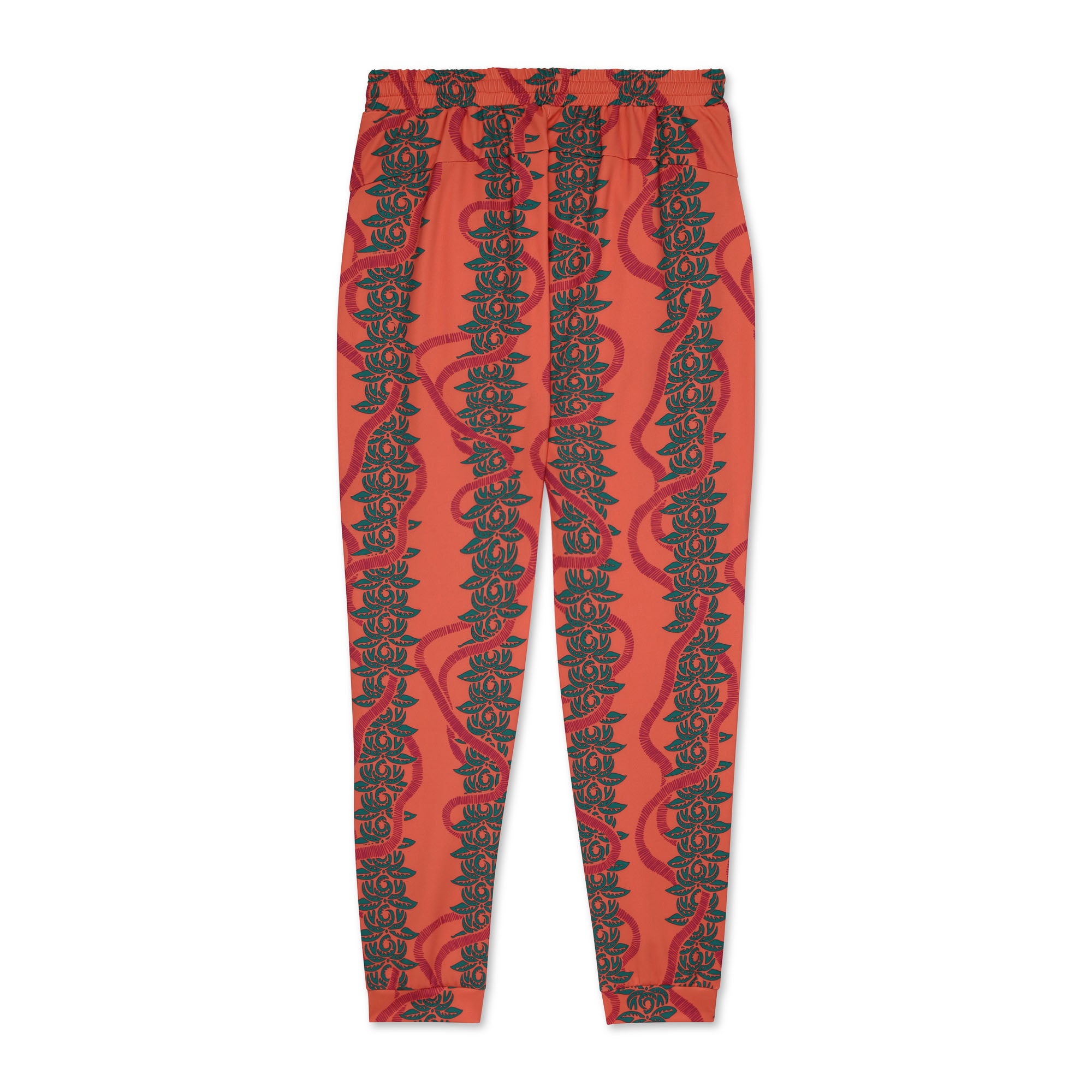 Pink jogger pants with green leaf pattern on a white background