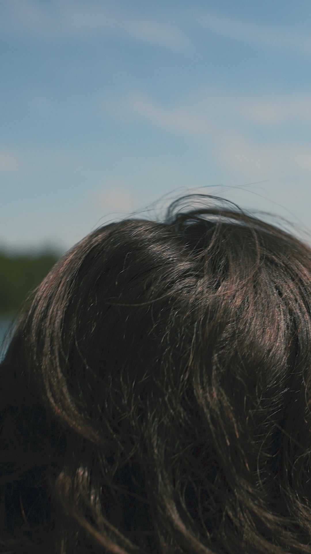 Girl putting a hat on backwards over her head