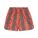 Pink shorts with green leaf pattern on a white background