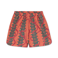 Pink shorts with green leaf pattern on a white background