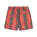 Pink shorts with green leaf pattern on a white background.