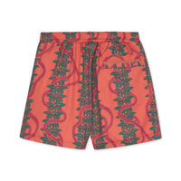 Pink shorts with green leaf pattern on a white background.