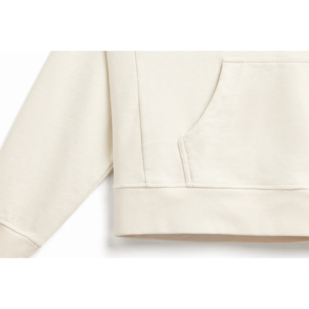 Bottom of body and arm ribbing detail of natural, off-white hoodie.