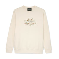 Cream sweatshirt with floral design and text on a white background 