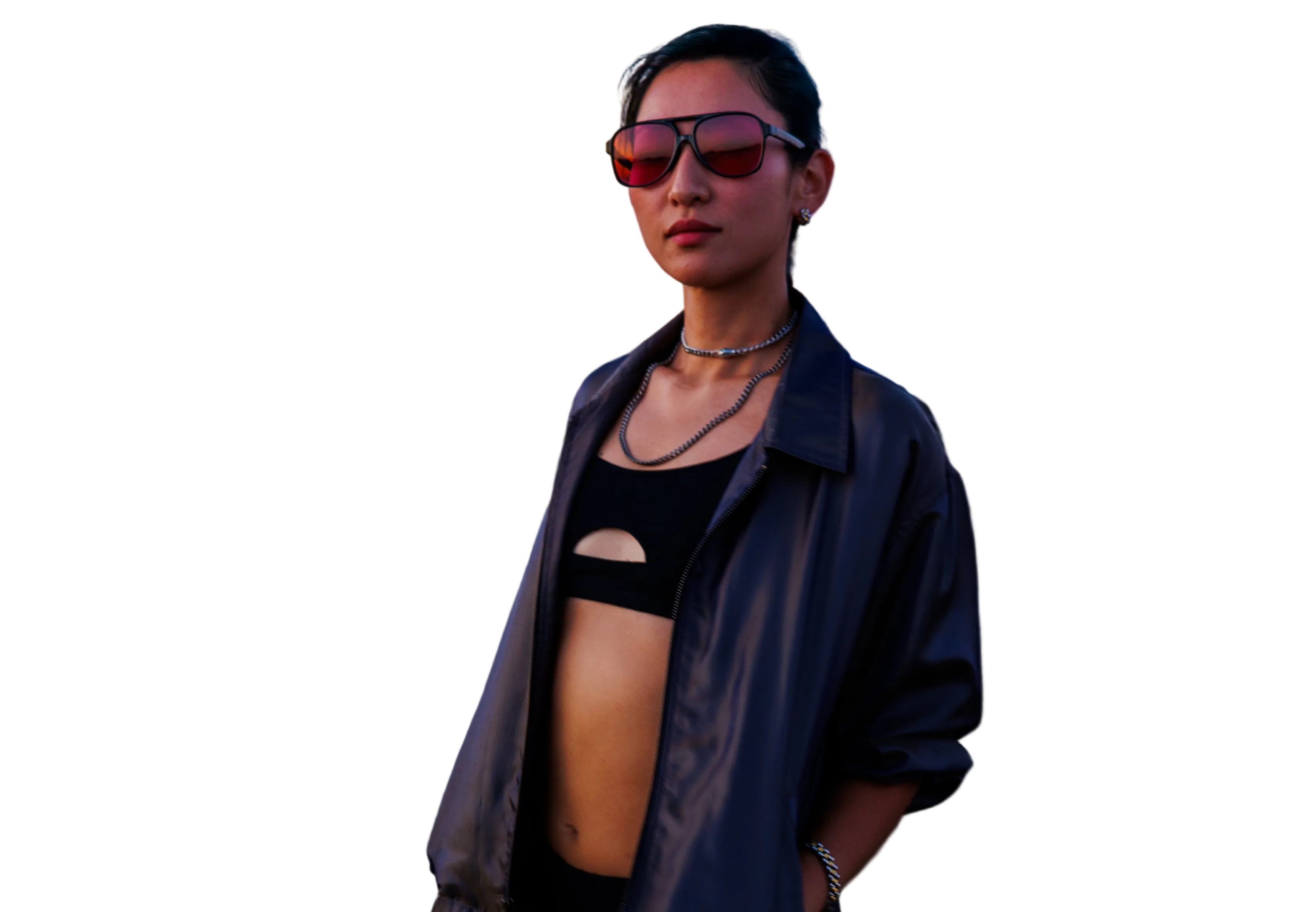 Person wearing sunglasses and a black top at a music festival with a blurred crowd in the background.