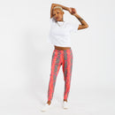 Person stretching their arms behind their head and wearing a white t-shirt and pink jogger pants with green leaf pattern on a white background 