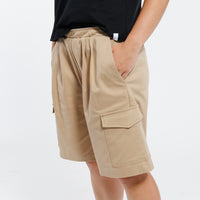 Khaki Bermuda shorts worn by a person on a white background